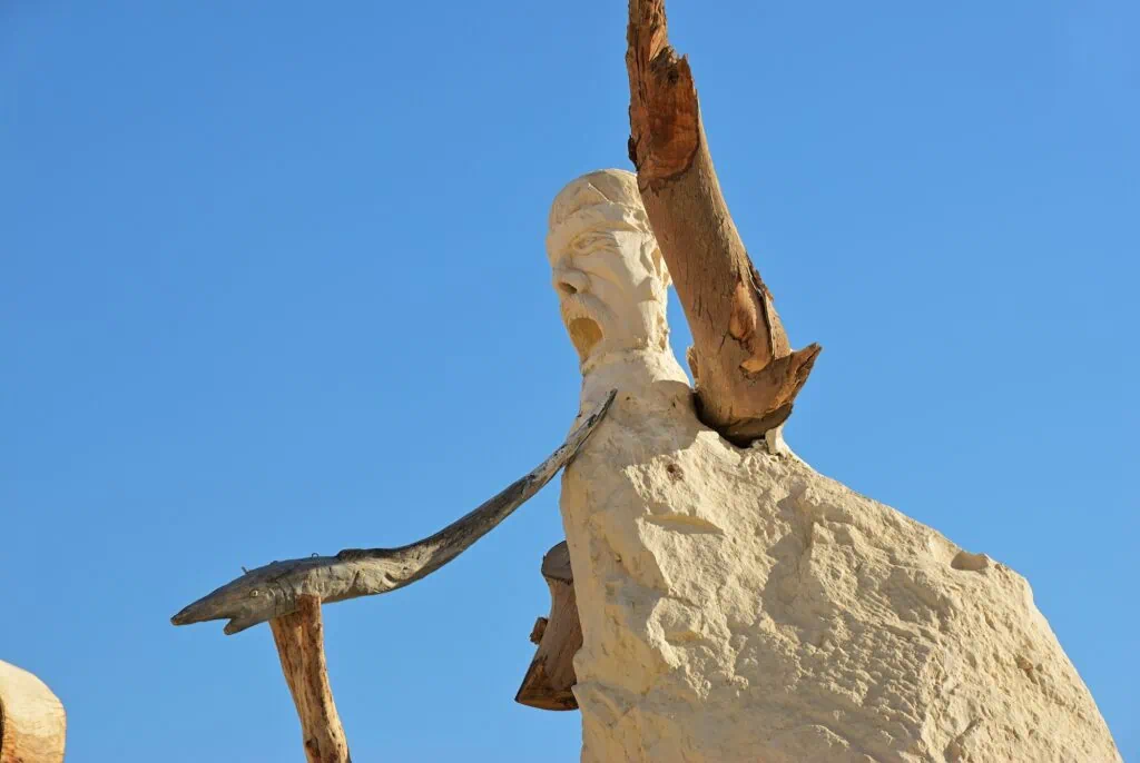 Figure of a man holding a fish displayed at the Badr Museum, Farafra Oasis