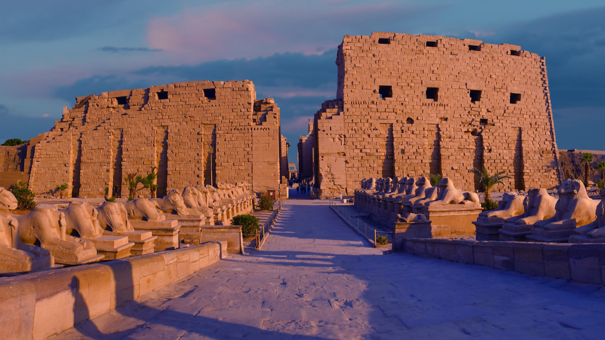 Ancient columns and ram-headed sphinxes at Karnak Temple Complex courtyard