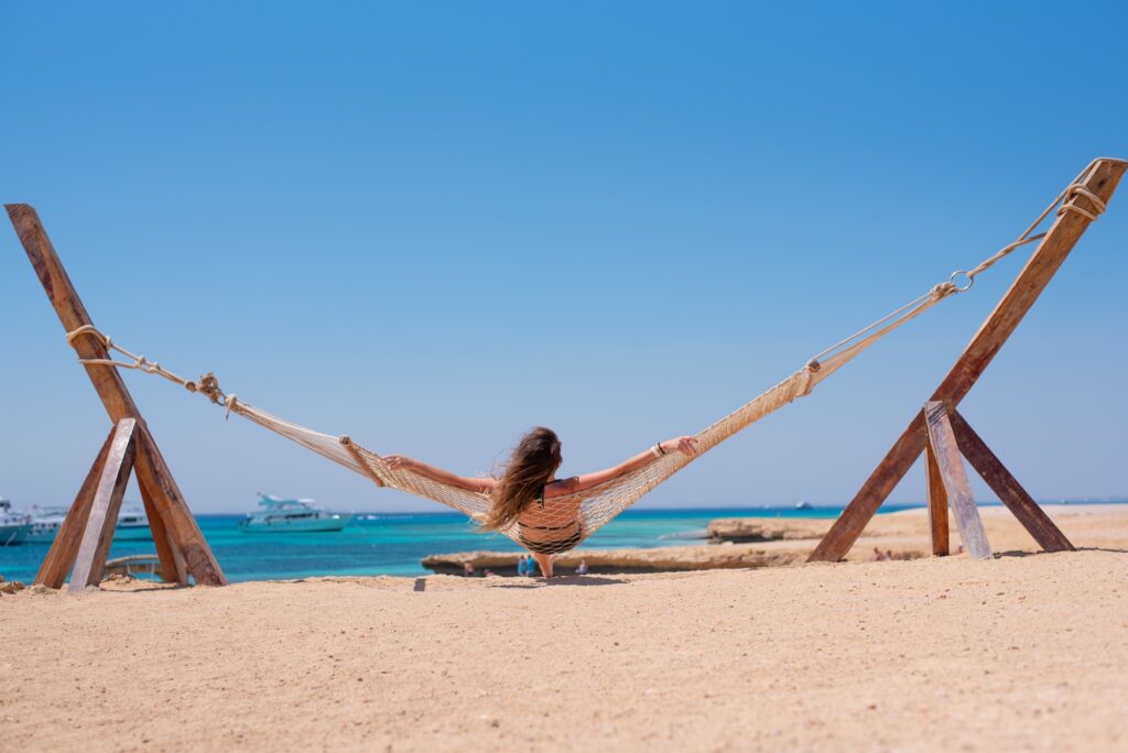 Woman enjoying a peaceful moment in a hammock at Orange Bay, Hurghada