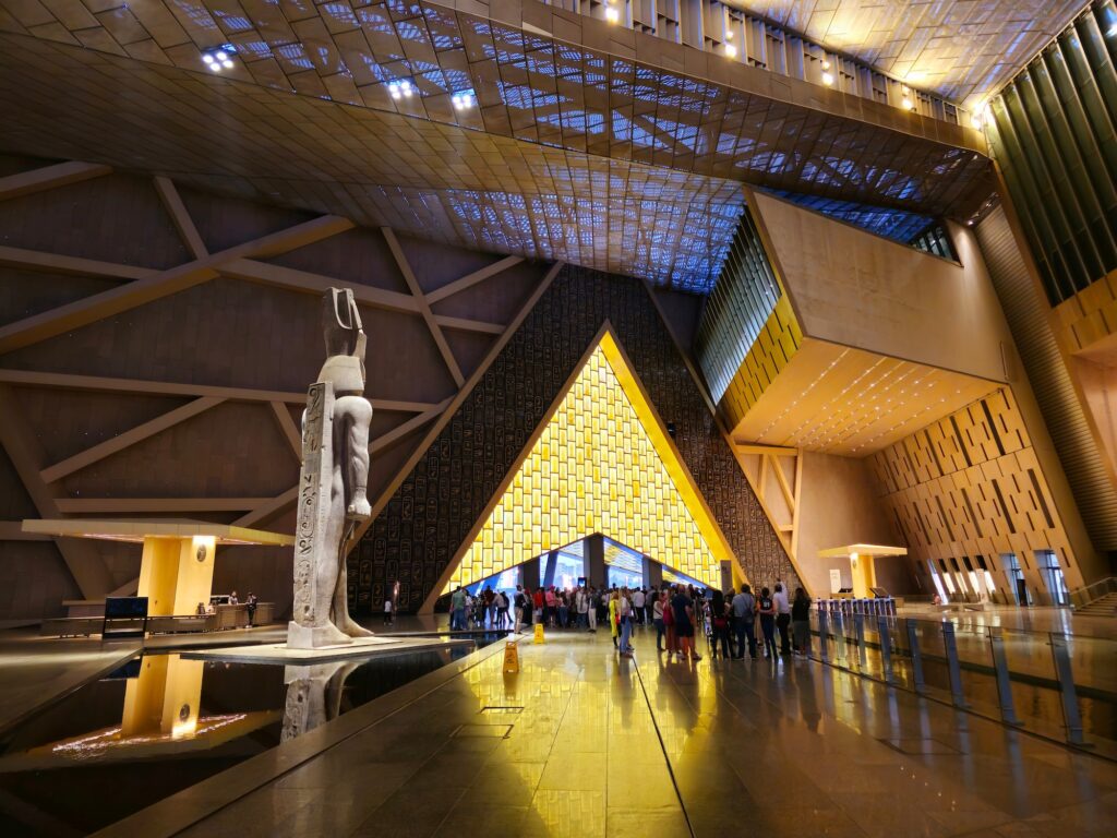 Grand hall with high ceilings and large statues at the entrance of the Grand Egyptian Museum, Giza