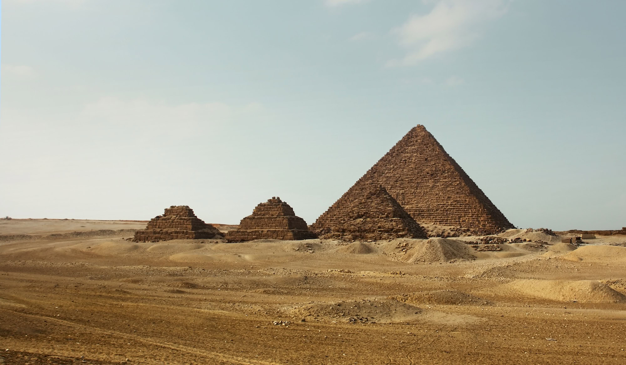 Pyramids of Giza standing majestically in the Egyptian desert landscape