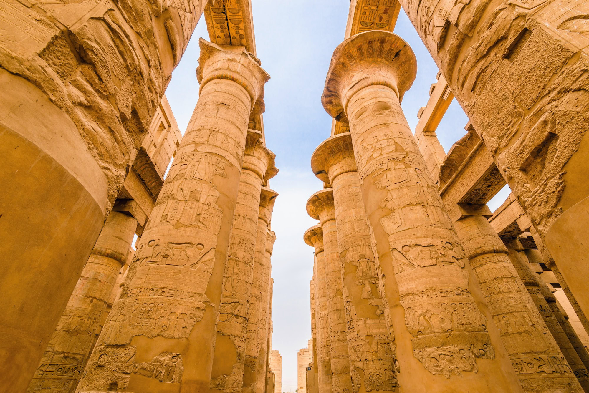 Massive stone columns with hieroglyphic carvings at Karnak Temple Complex