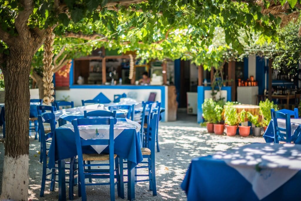 Traditional Greek taverna with outdoor tables set along a street