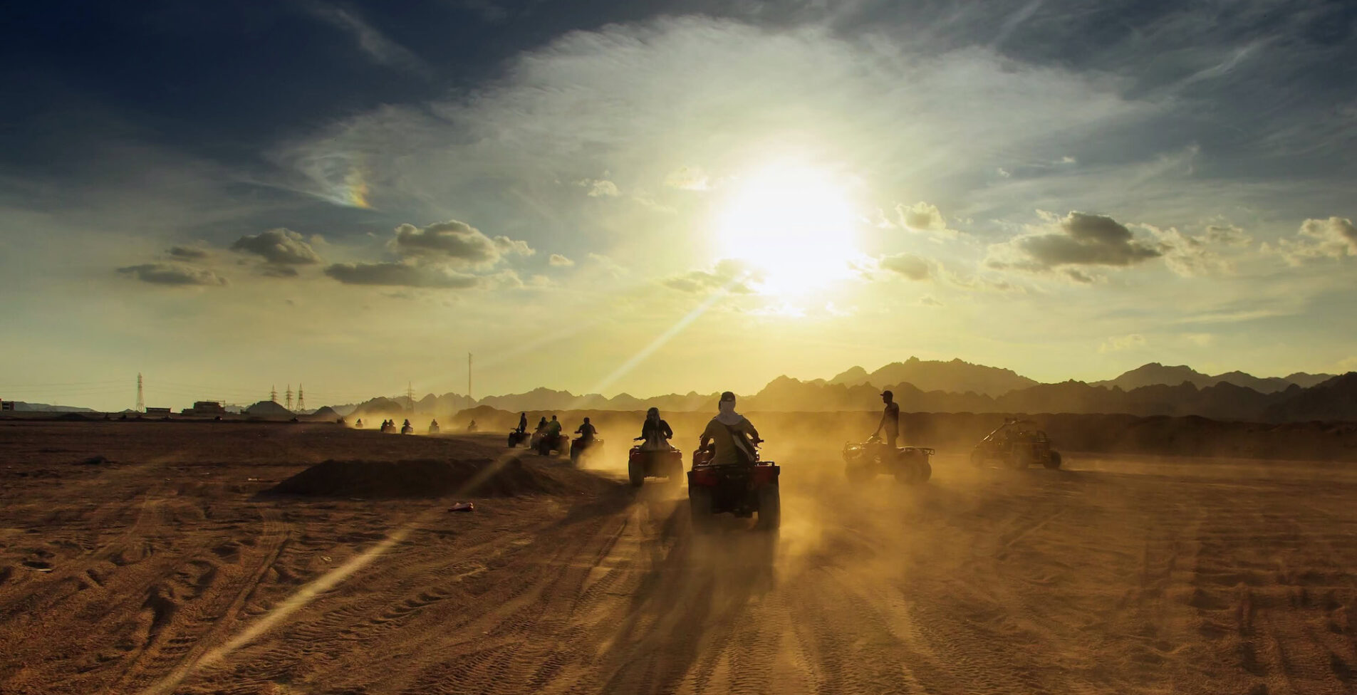 Group of tourist on ATVs on Egyptian desert. Colored reworked 1905x976 crop 46 61