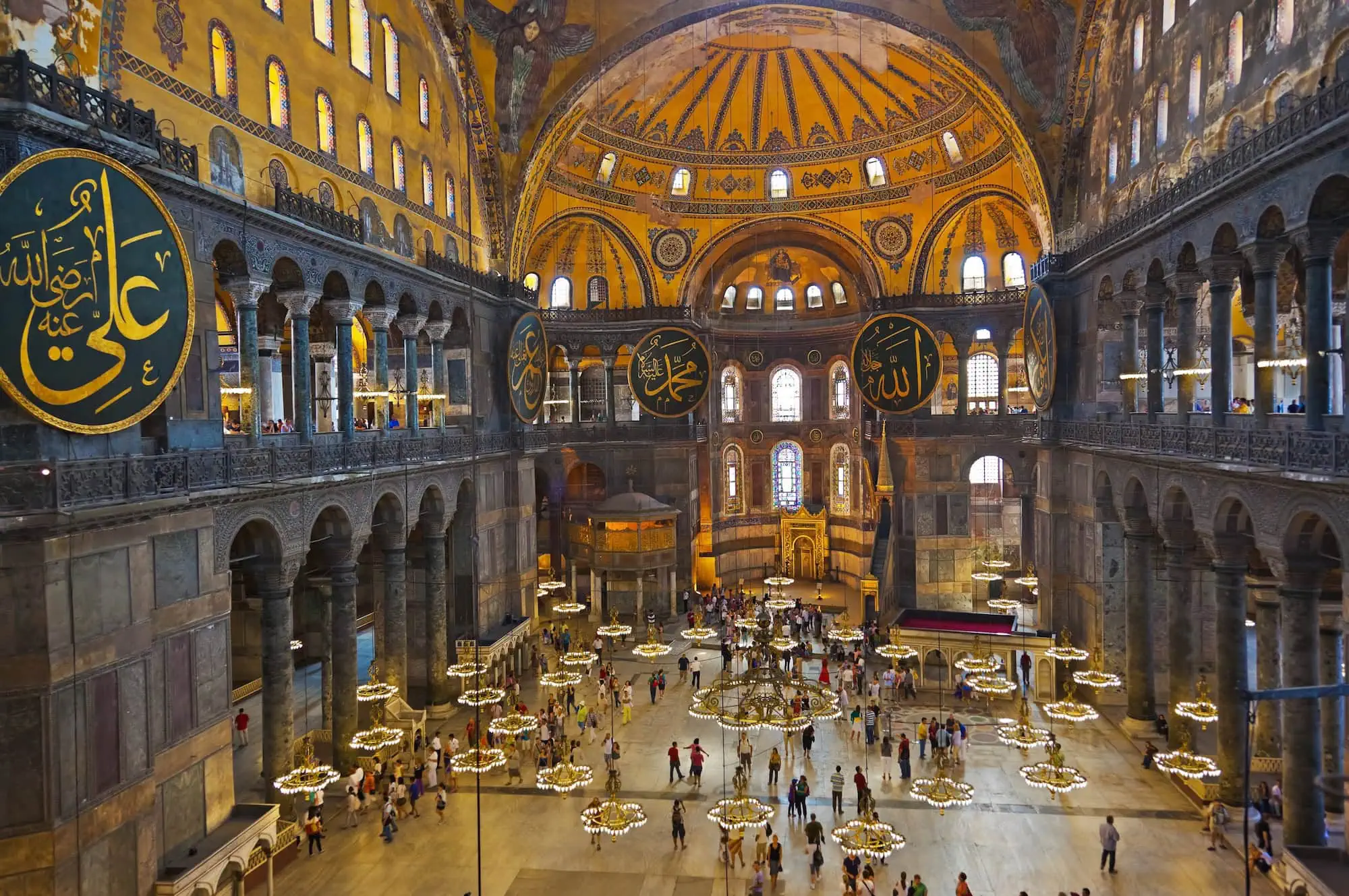 Interior of Hagia Sophia with magnificent dome, columns, and Islamic calligraphy
