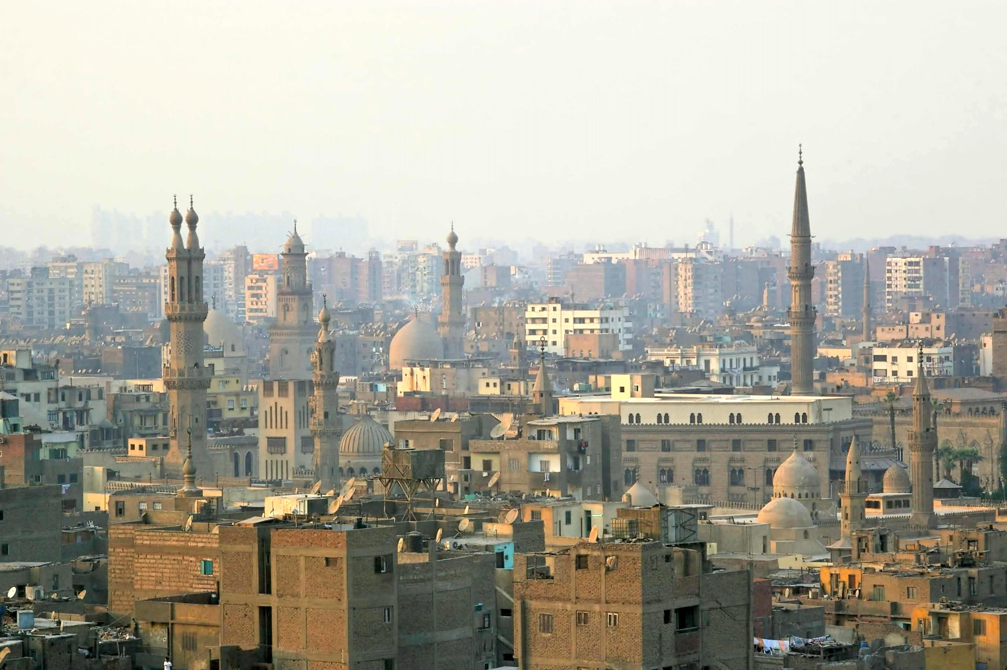High density living in the smog and setting sun old Islamic Cairo quarter Egypt