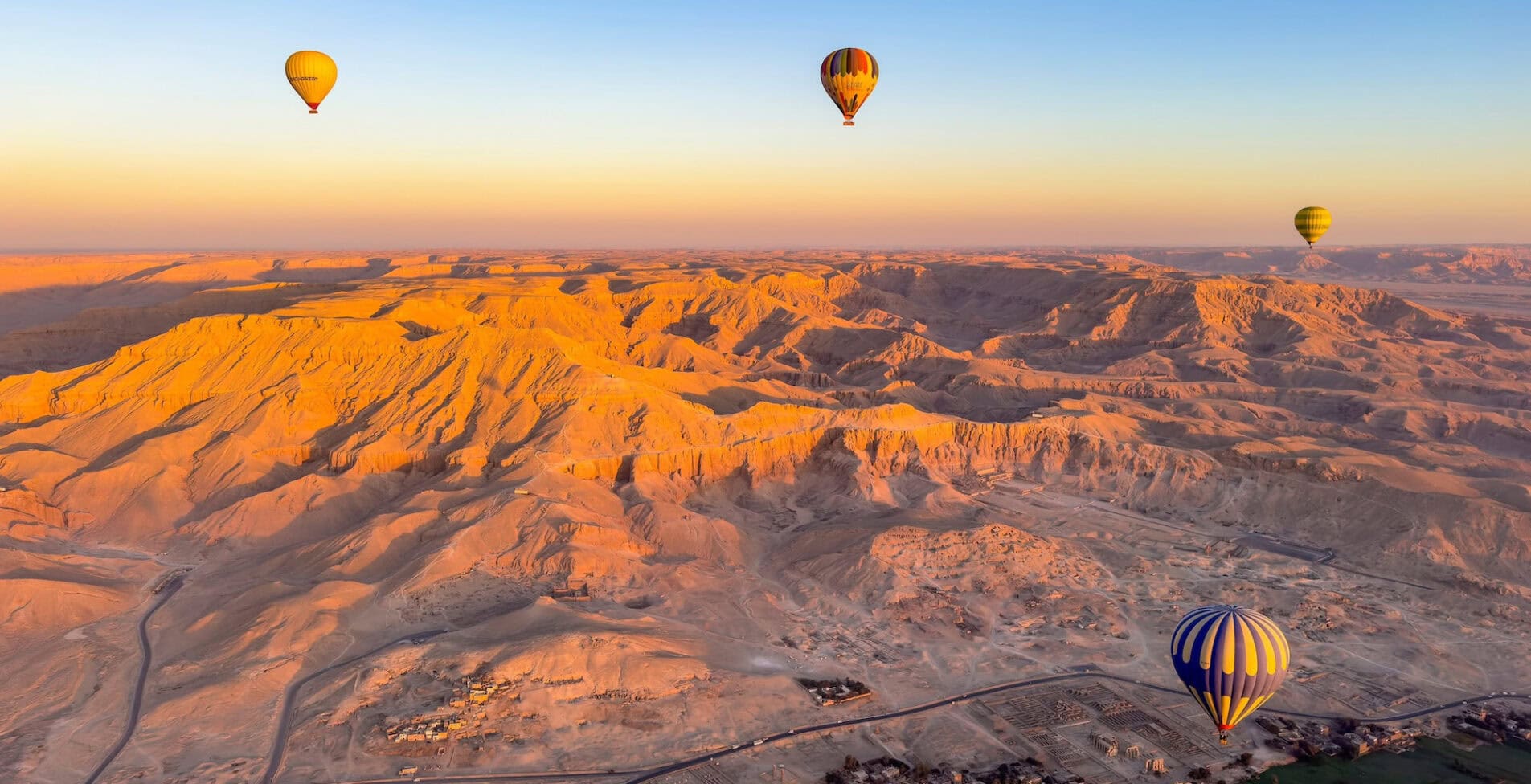 Hot air balloon show gracefully hovering over Luxor Egypt. Panoramic views of the fertile Nile Valley and the vast Sahara Desert home to countless treasures