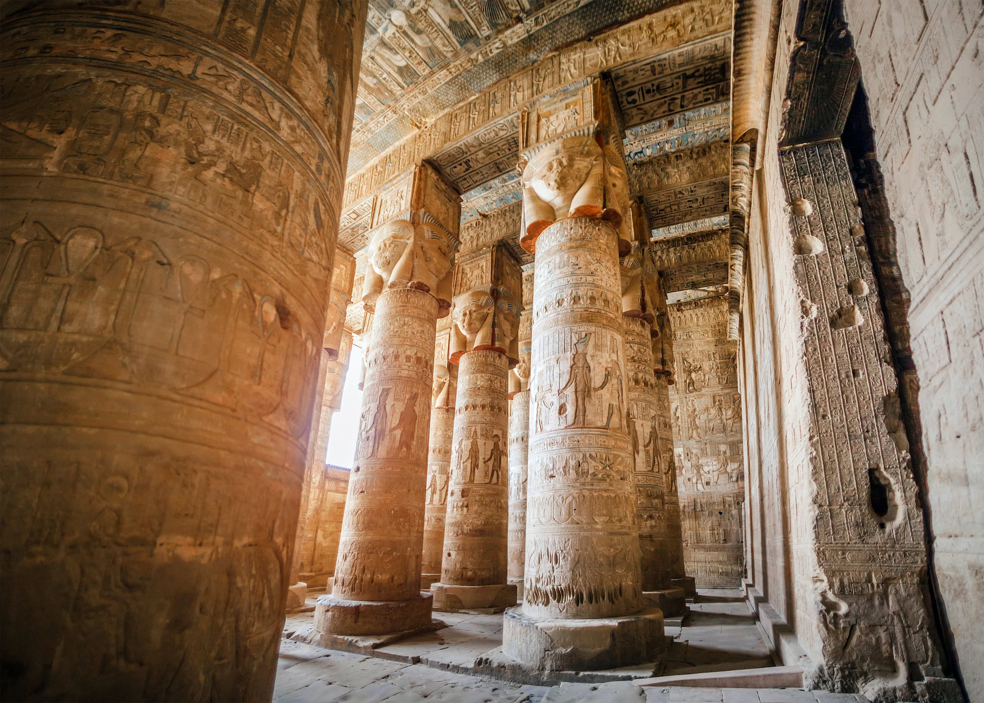 Interior of Temple of Hathor at Dendera showing carved columns with Hathor capitals and hieroglyphic reliefs