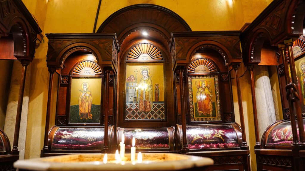 Painted icons depicting Saint Barbara displayed on the walls and iconostasis inside the Coptic Orthodox Church of Saint Barbara, Cairo
