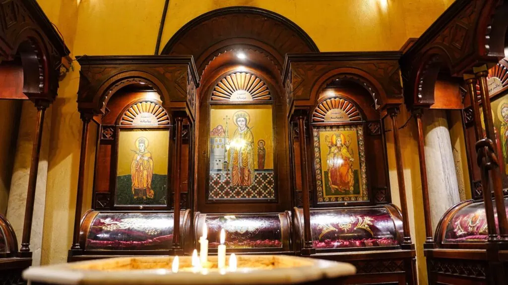 Painted icons depicting Saint Barbara displayed on the walls and iconostasis inside the Coptic Orthodox Church of Saint Barbara, Cairo