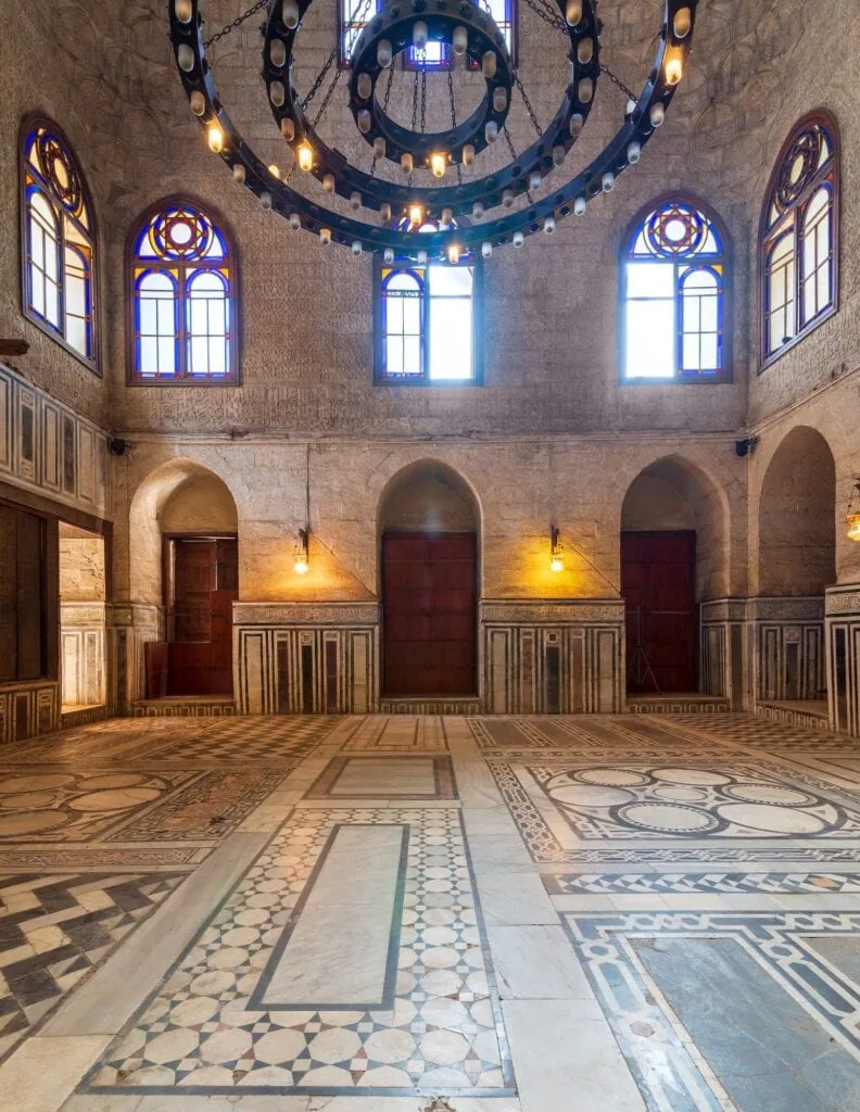 Interior hall of Sultan al-Ghuri Mausoleum with decorated marble floor, stained glass windows, and stone brick walls, Sultan al-Ghuri Mausoleum, Cairo