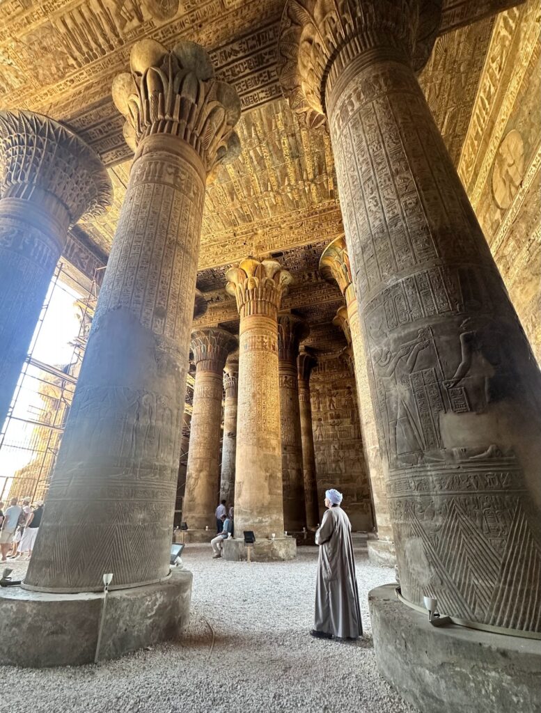 Interior view of carved stone columns with hieroglyphic reliefs inside the Temple of Khnum, Esna