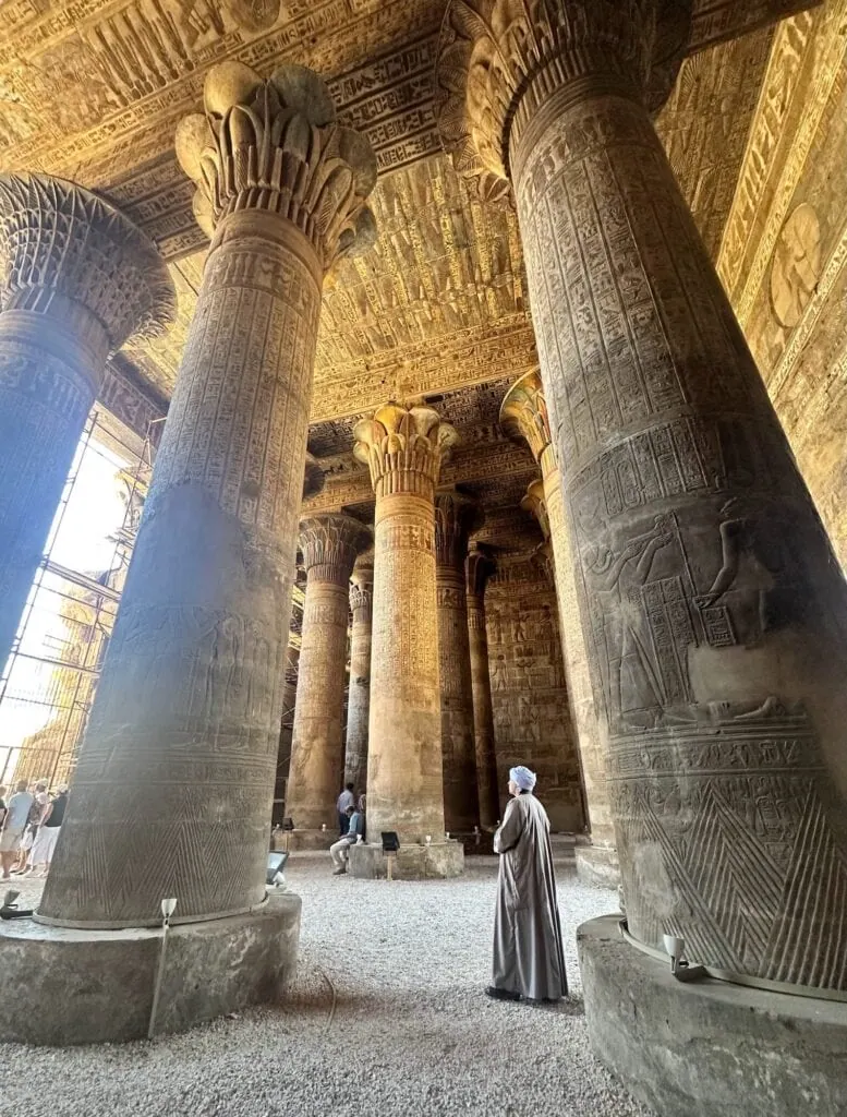 Interior view of carved stone columns with hieroglyphic reliefs inside the Temple of Khnum, Esna