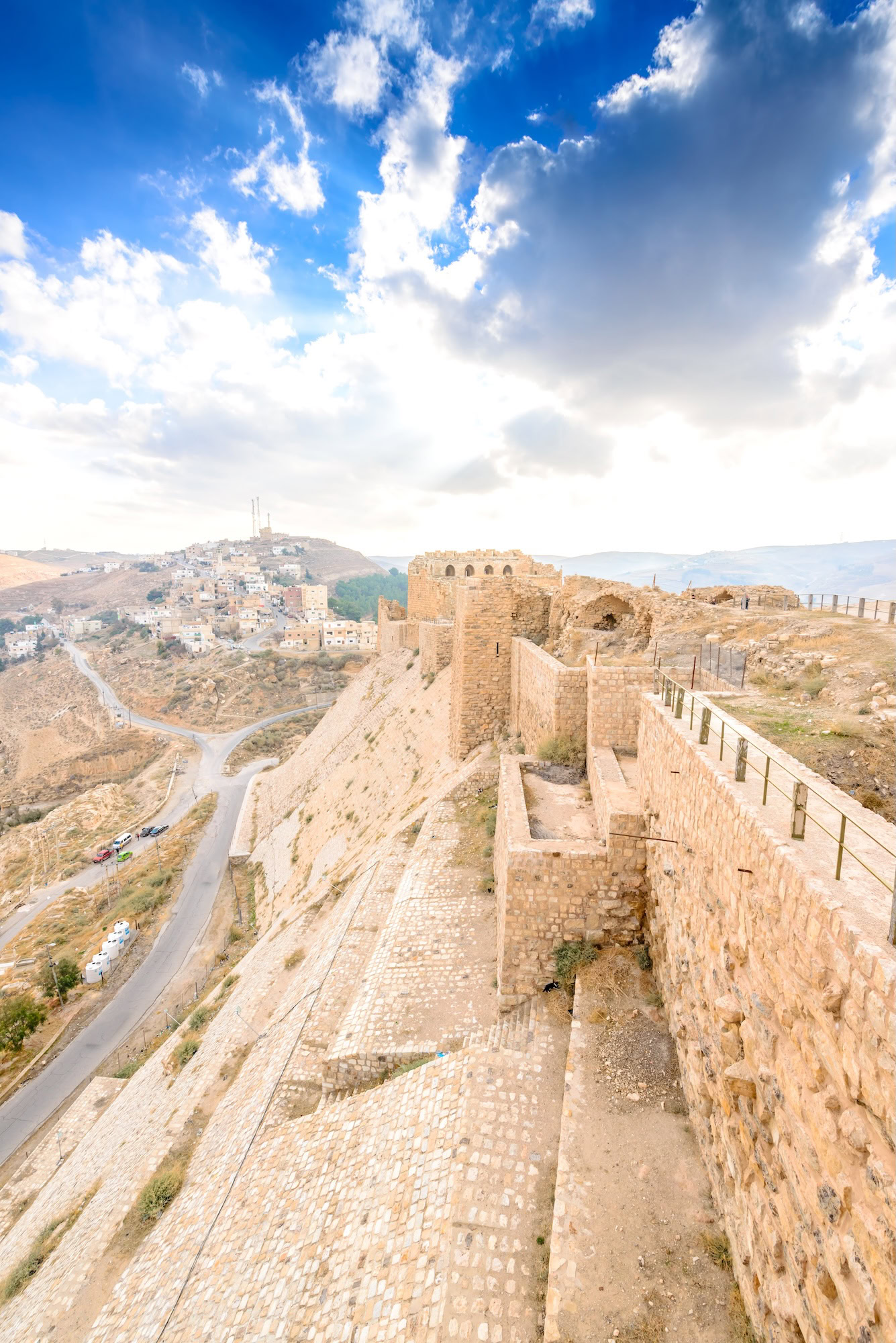 Kerak Castle fortress with stone towers and battlements overlooking mountains in Jordan