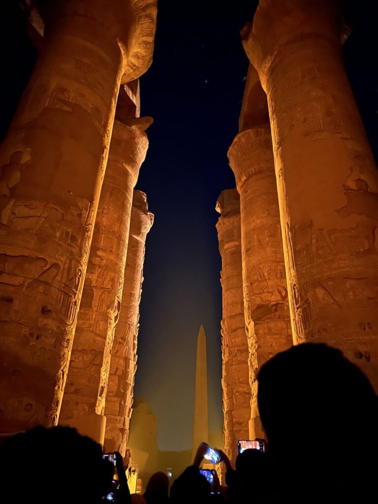 Illuminated stone pillars highlighted during the Sound and Light show at Karnak Temple, Luxor