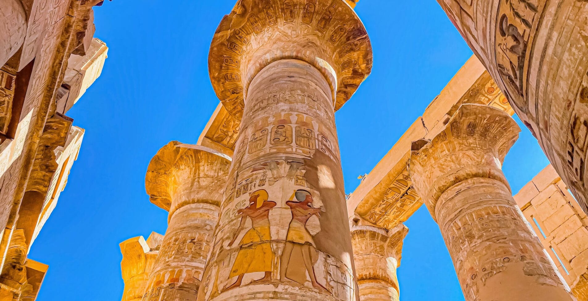 Karnak Temple is dedicated to the temple complex of Ancient Egypt in honor of the god Amun Ra his wife Mut and son Khons. Thebes Karnak Luxor Egypt 1 1905x976 crop 40 82