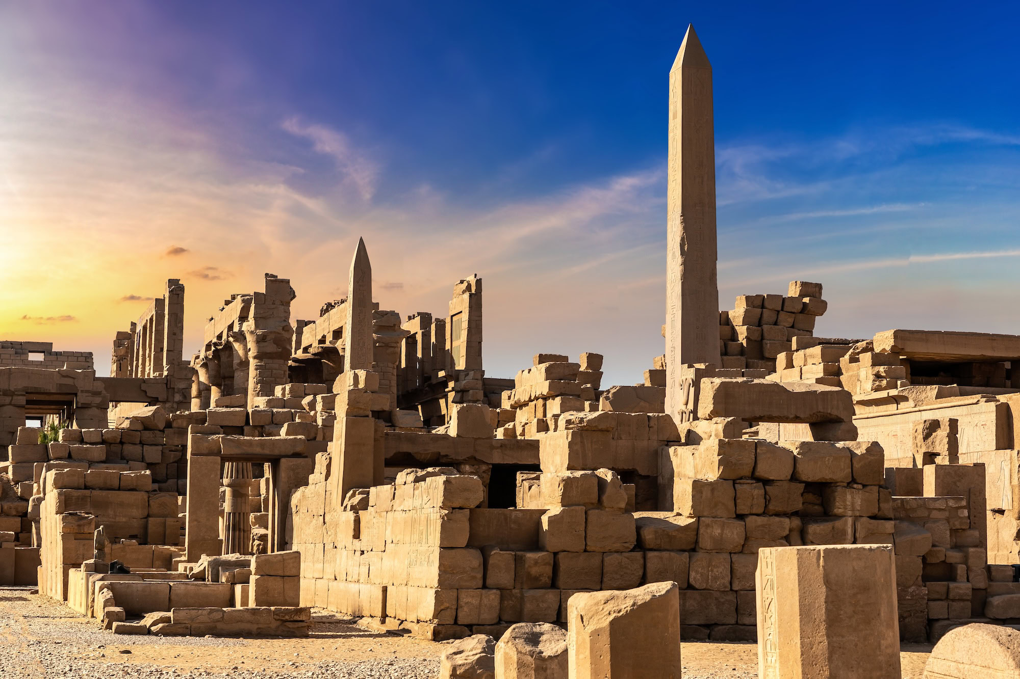 Expansive view of Karnak Temple Complex showing obelisk and vast ancient ruins under cloudy sky