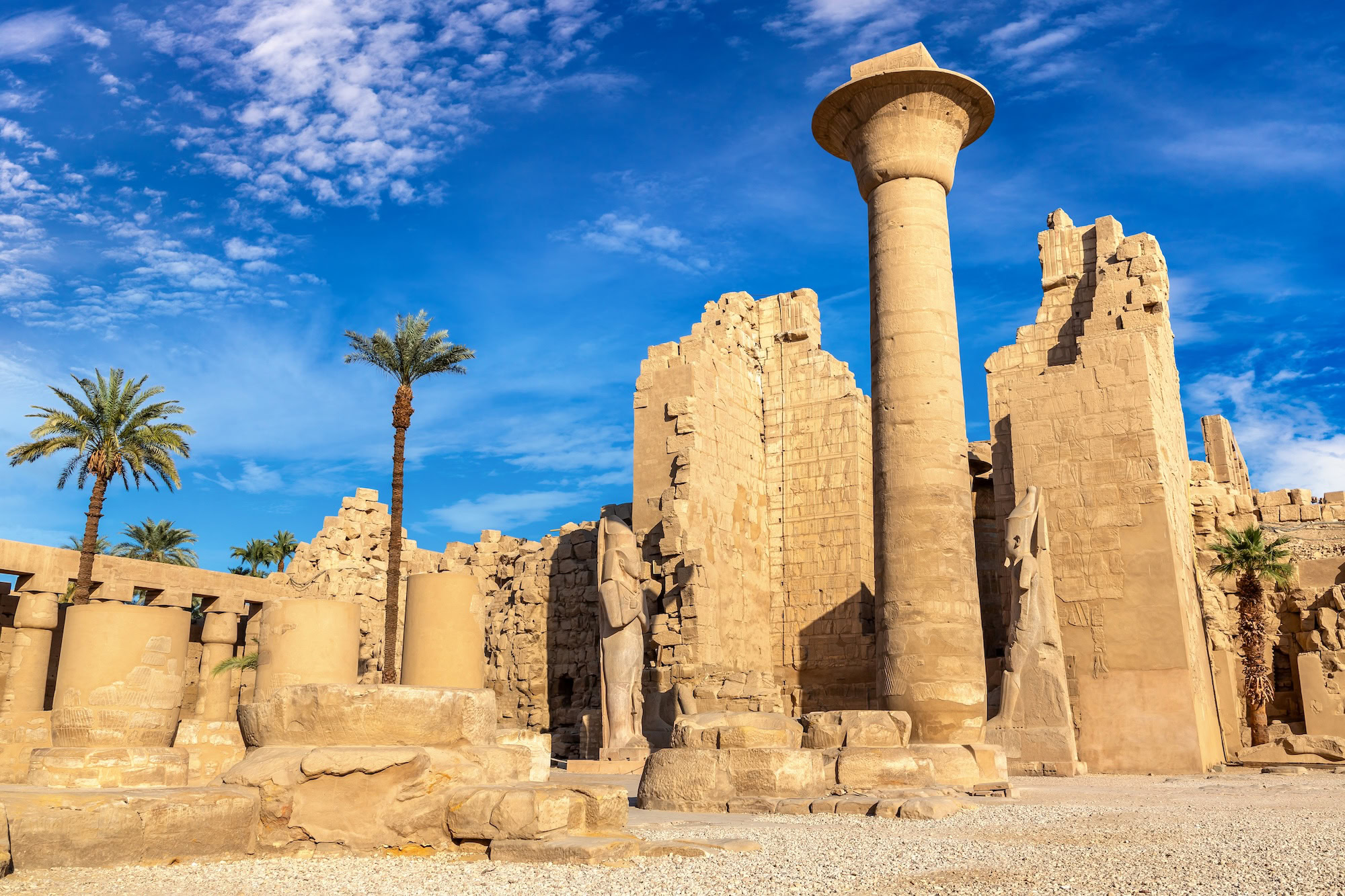 Ancient stone columns with hieroglyphic carvings at Karnak Temple Complex in Luxor, Egypt