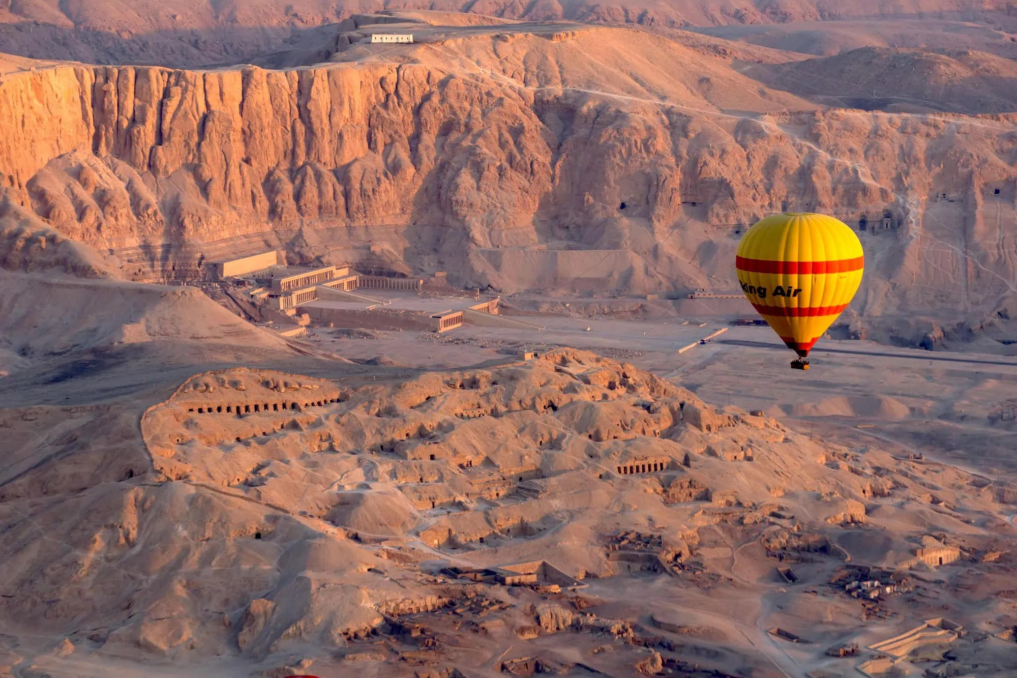 Aerial view of Valley of the Kings archaeological sites taken from hot air balloon during golden hour