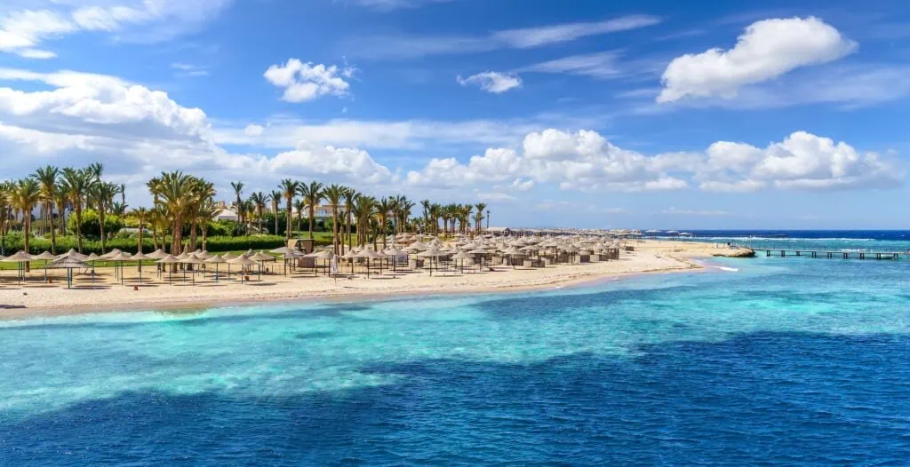 Beachfront landscape with marina and coastal buildings along the Red Sea shore, Port Ghalib