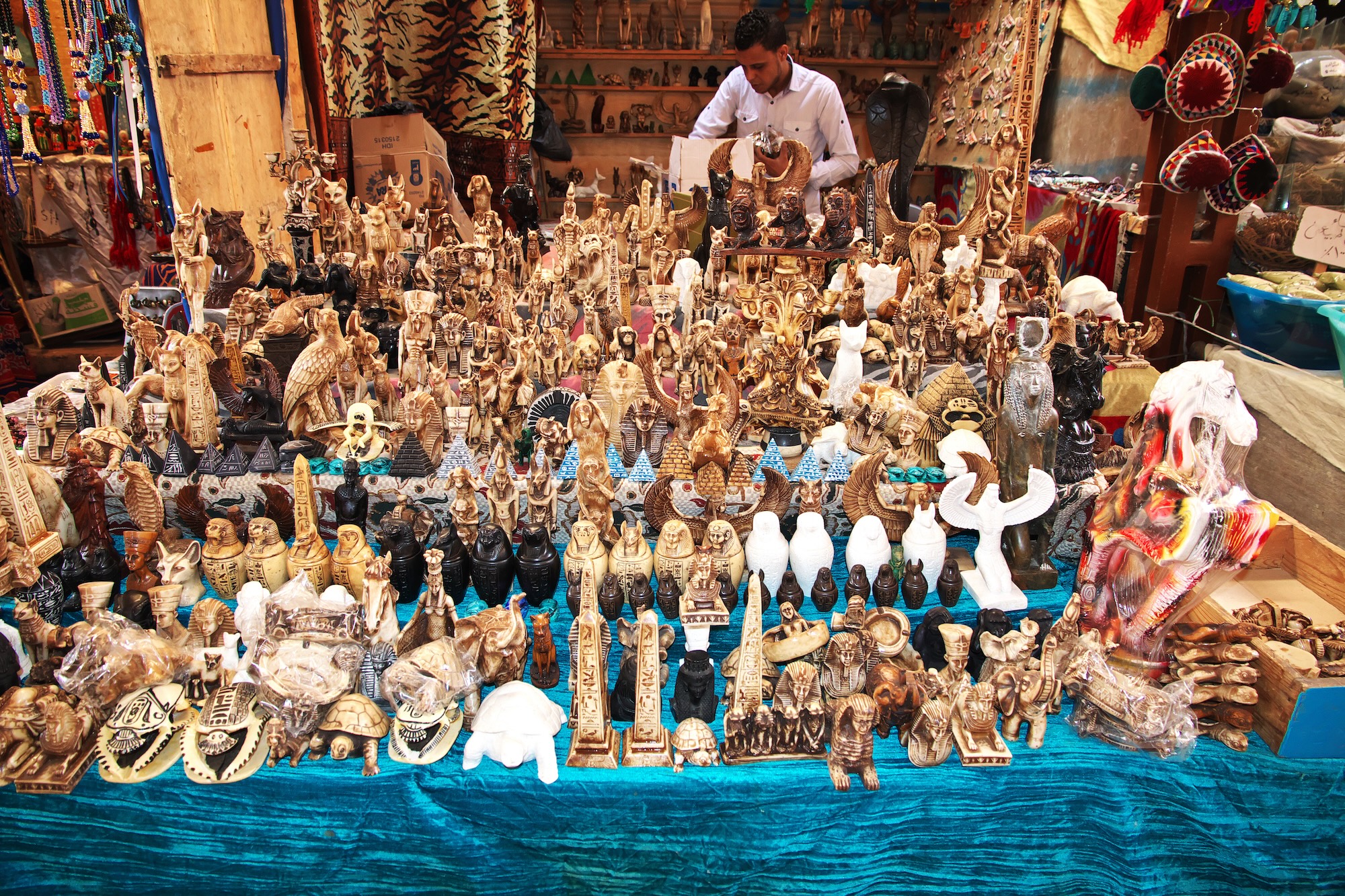 Egyptian souvenir market stall displaying pharaoh figurines and traditional crafts