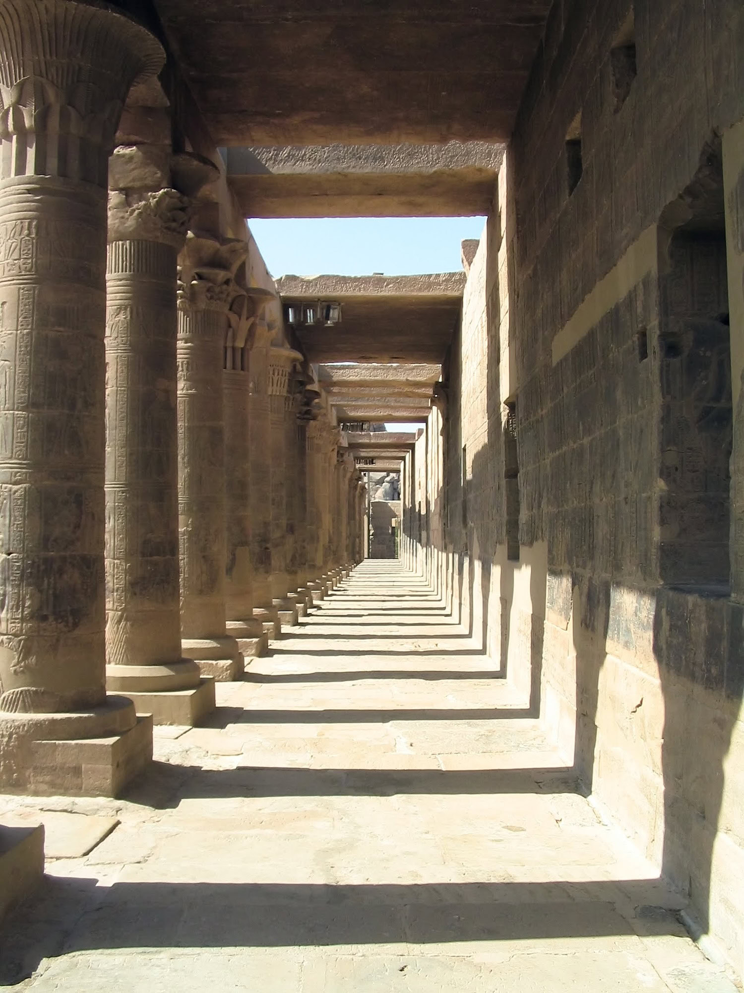 Interior colonnade of Edfu Temple showing rows of columns with hieroglyphic carvings