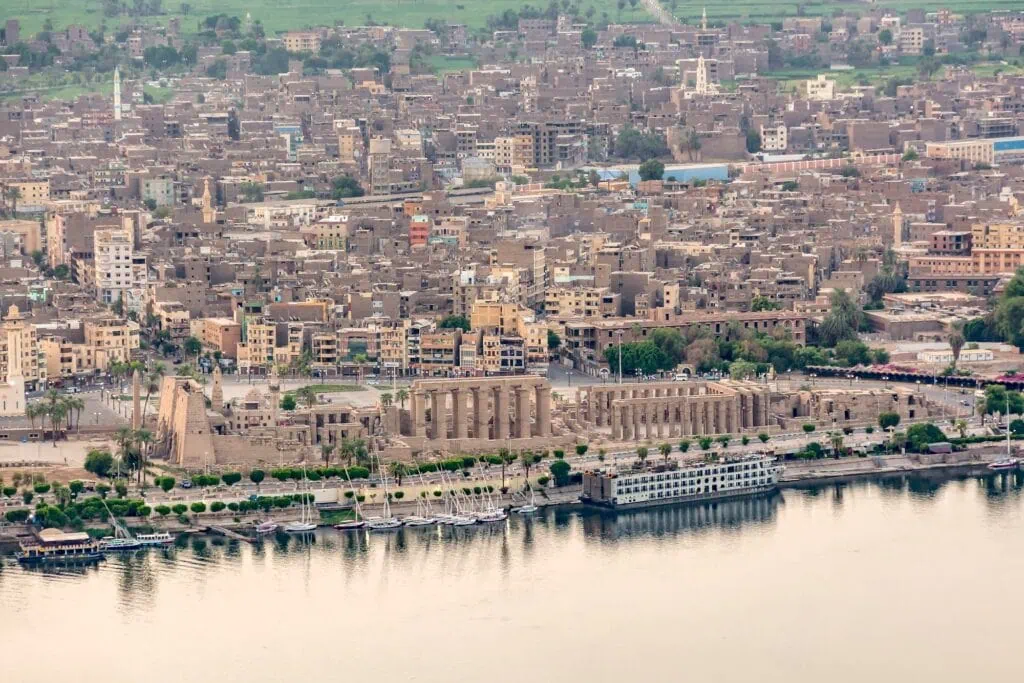 Aerial view showing Luxor Temple complex along the east bank of the Nile River, Luxor