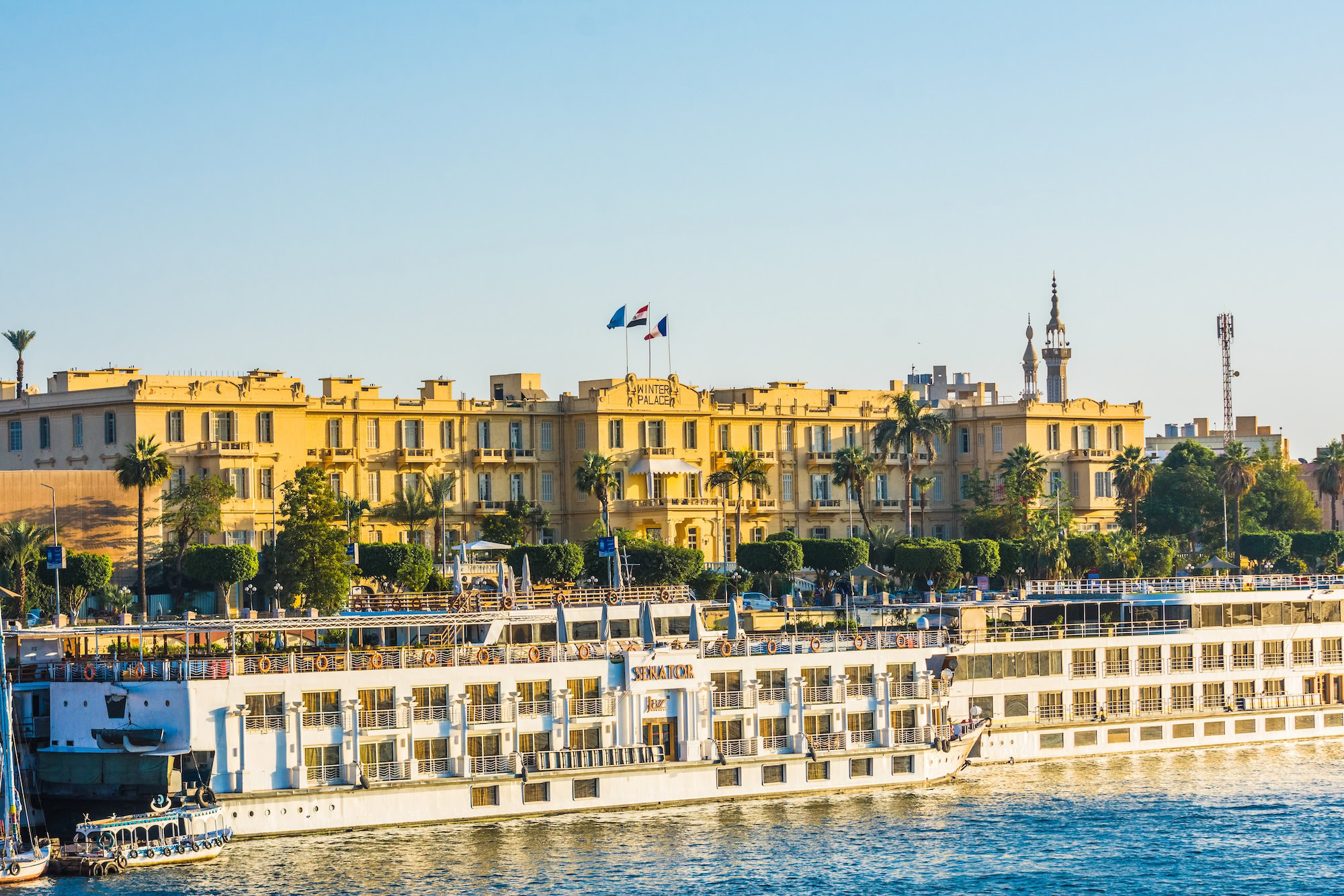 Historic Old Winter Palace hotel in Luxor with colonial architecture along the Nile River