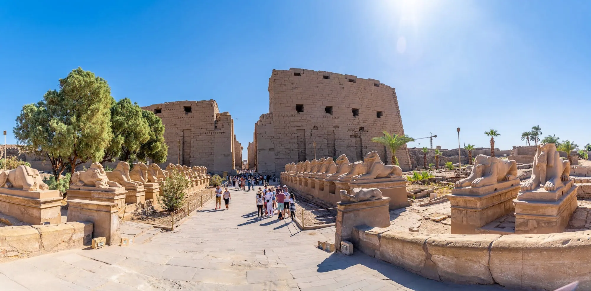 Ram-headed sphinx statues lining the ceremonial avenue at Karnak Temple Complex in Egypt