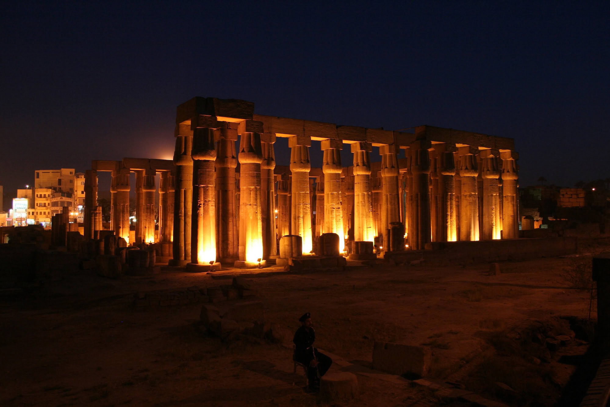 Night view of illuminated Luxor Temple with ancient columns and stone structures