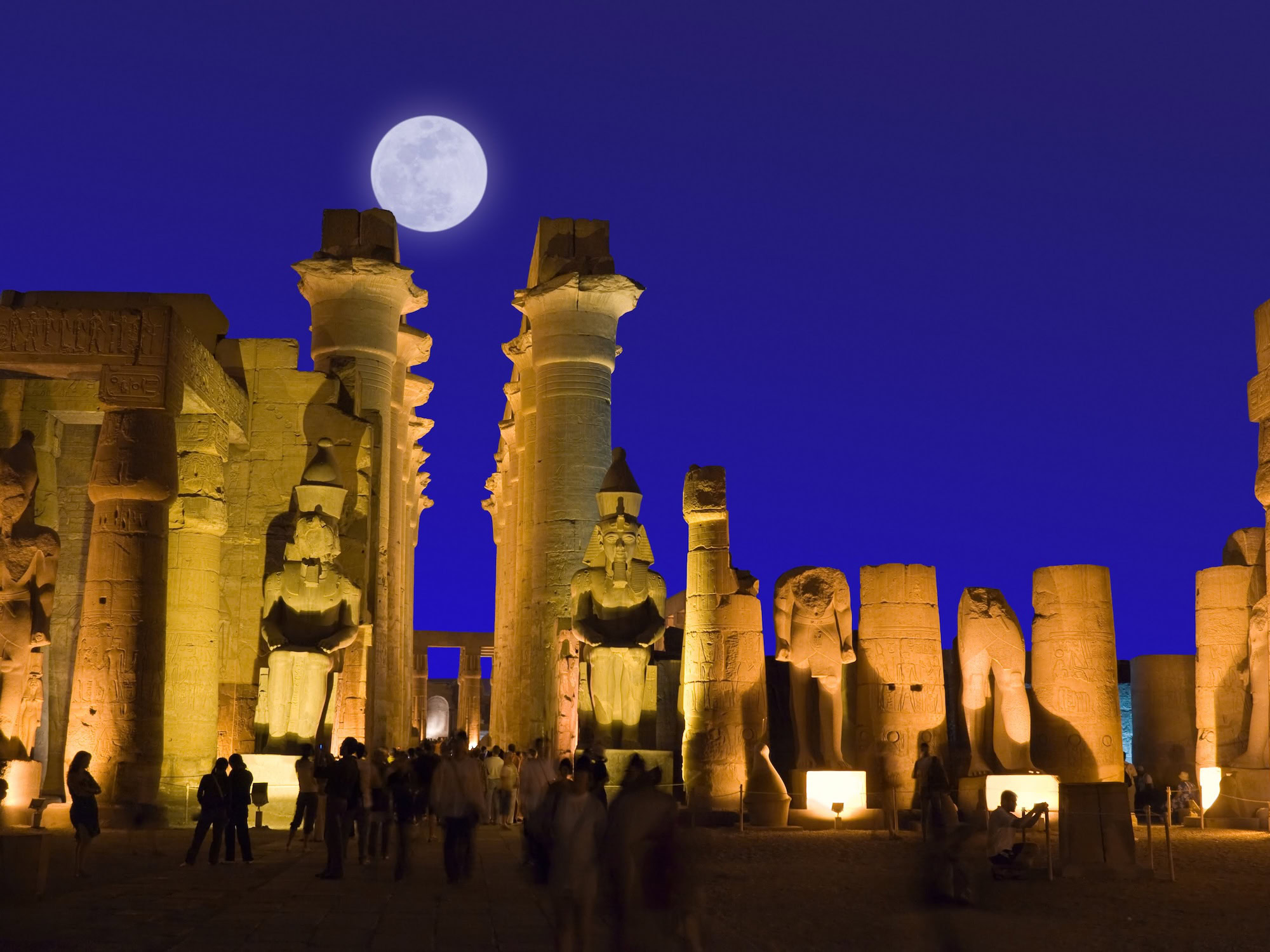 Luxor Temple illuminated at night with artificial lighting highlighting ancient columns and statues