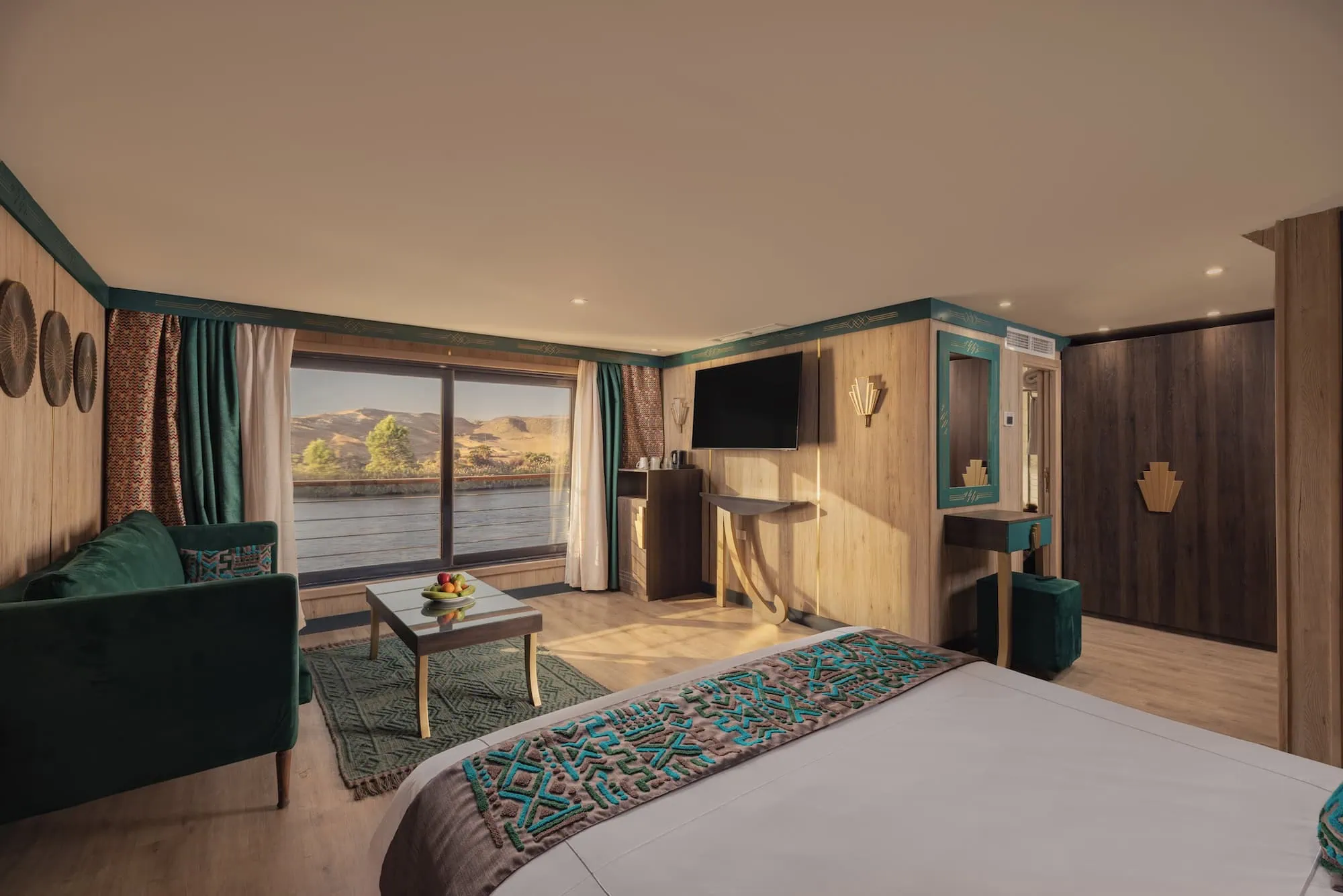 Luxury Nile cruise ship suite with panoramic river views and Egyptian-themed decor