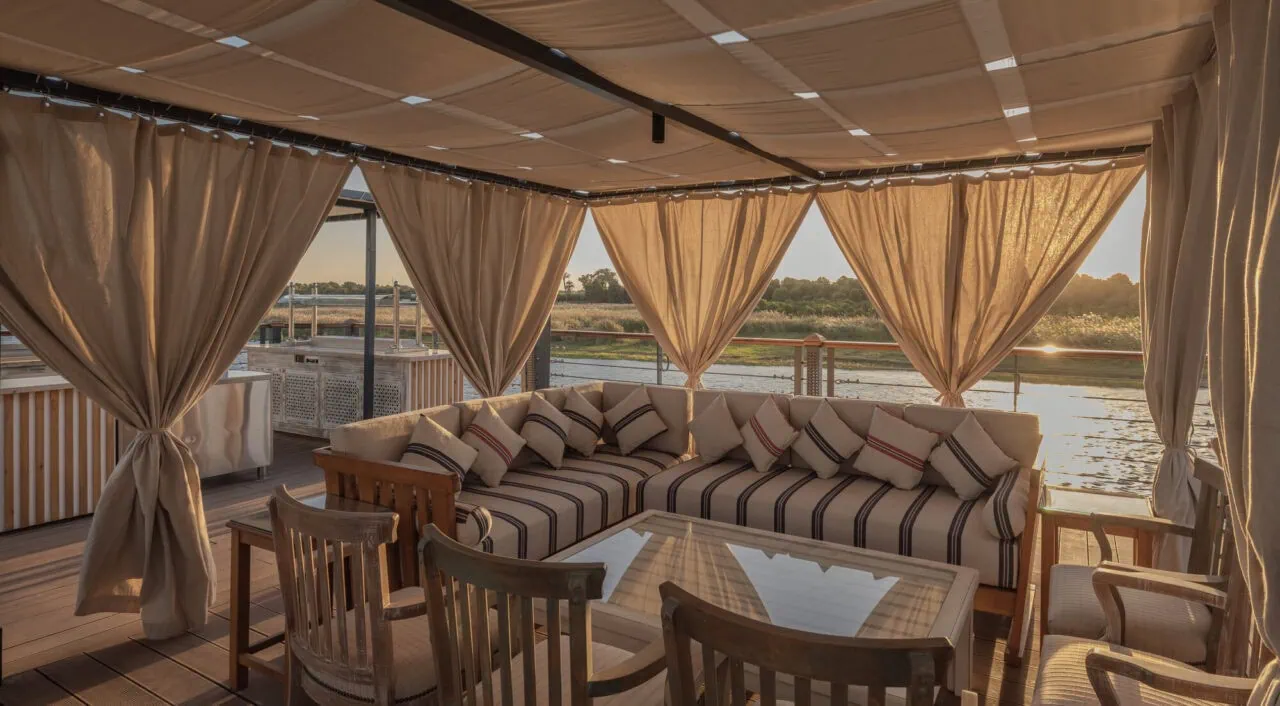Outdoor relax area on DWA Nile Cruise sun deck with shaded seating and Nile view