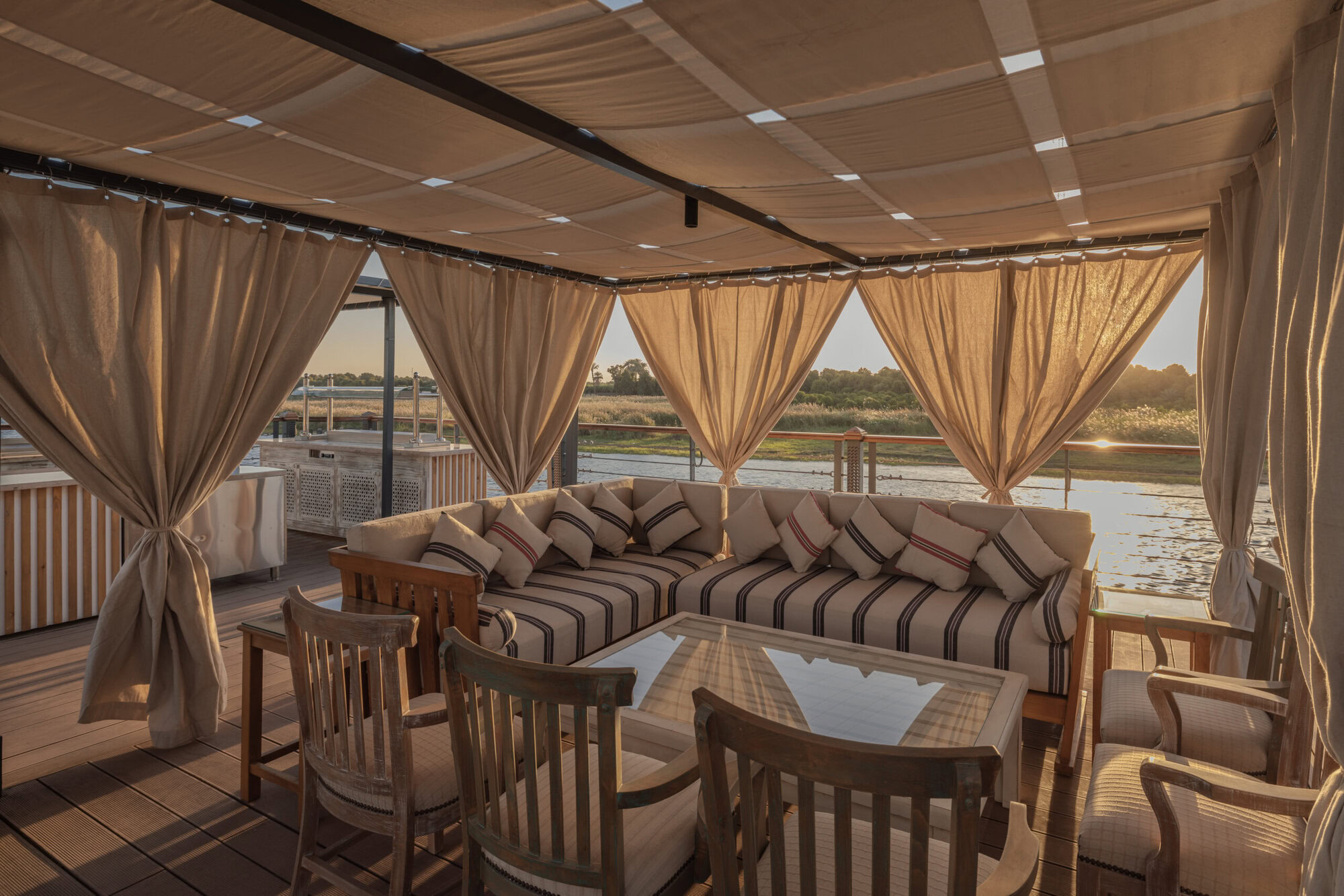 Outdoor relax area on DWA Nile Cruise sun deck with shaded seating and Nile view