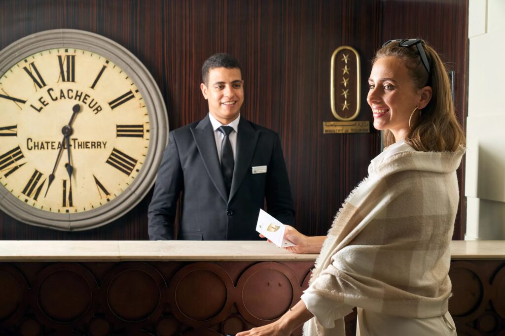 Receptionist welcoming a hotel guest