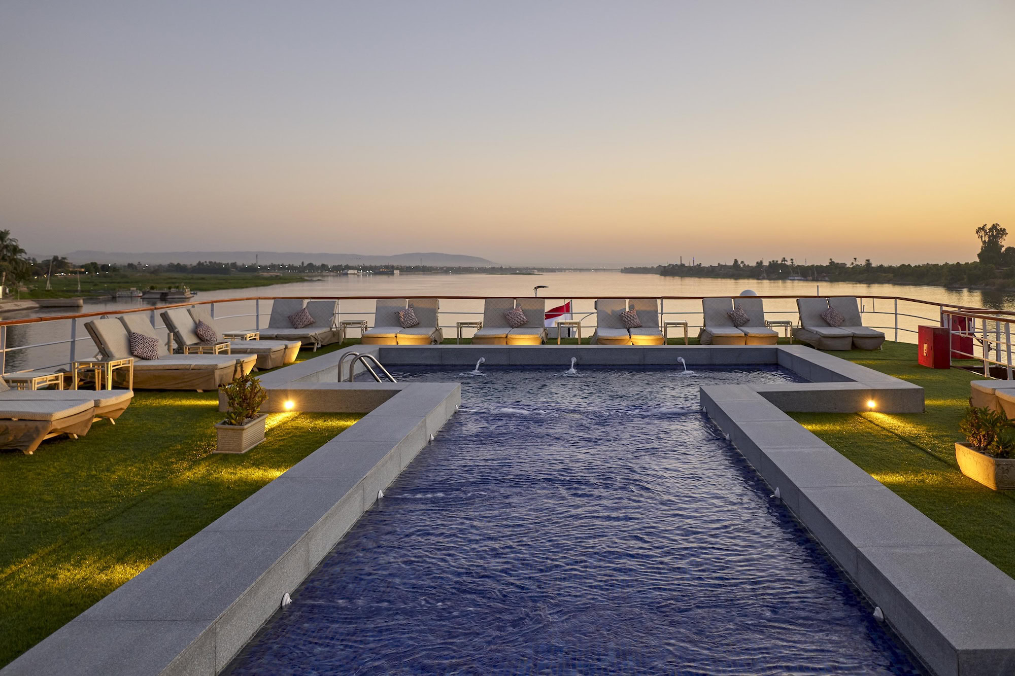 Outdoor pool on Mövenpick Royal Lily with sun loungers