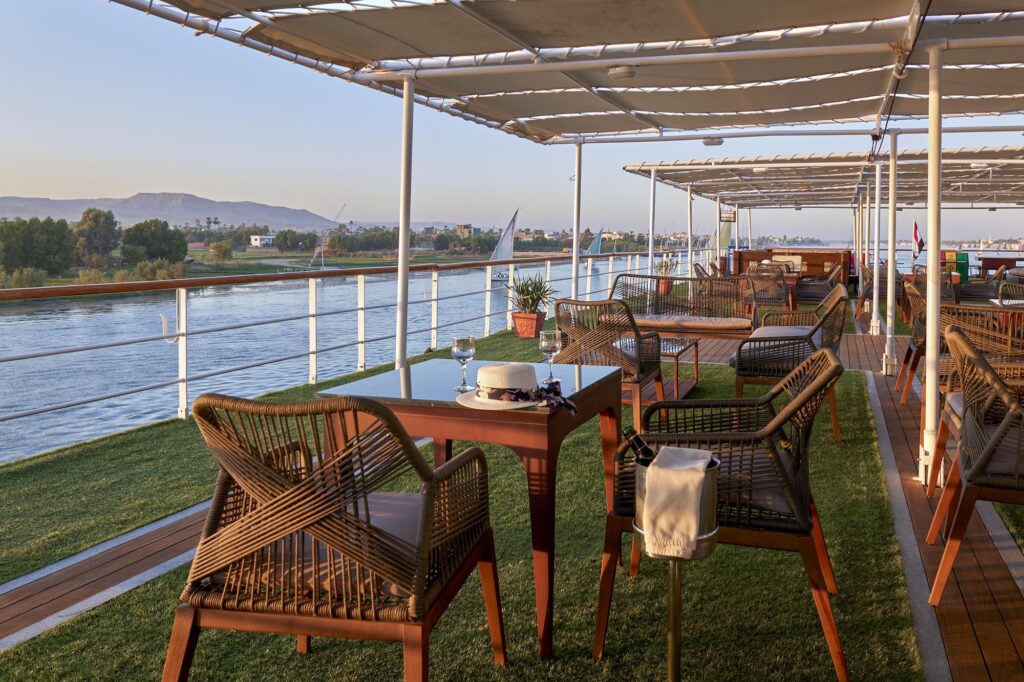 Outdoor tables and chairs on a Nile cruise sun deck