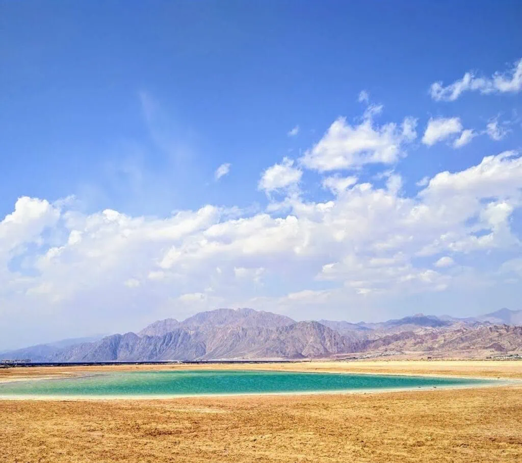 Magic Lake lagoon with shallow turquoise water and Sinai Mountains in the background, Dahab