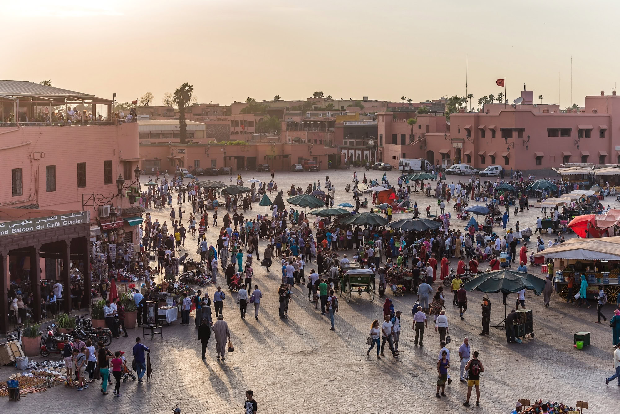 Bustling Jemaa el-Fnaa market square in Marrakech with crowds and traditional architecture