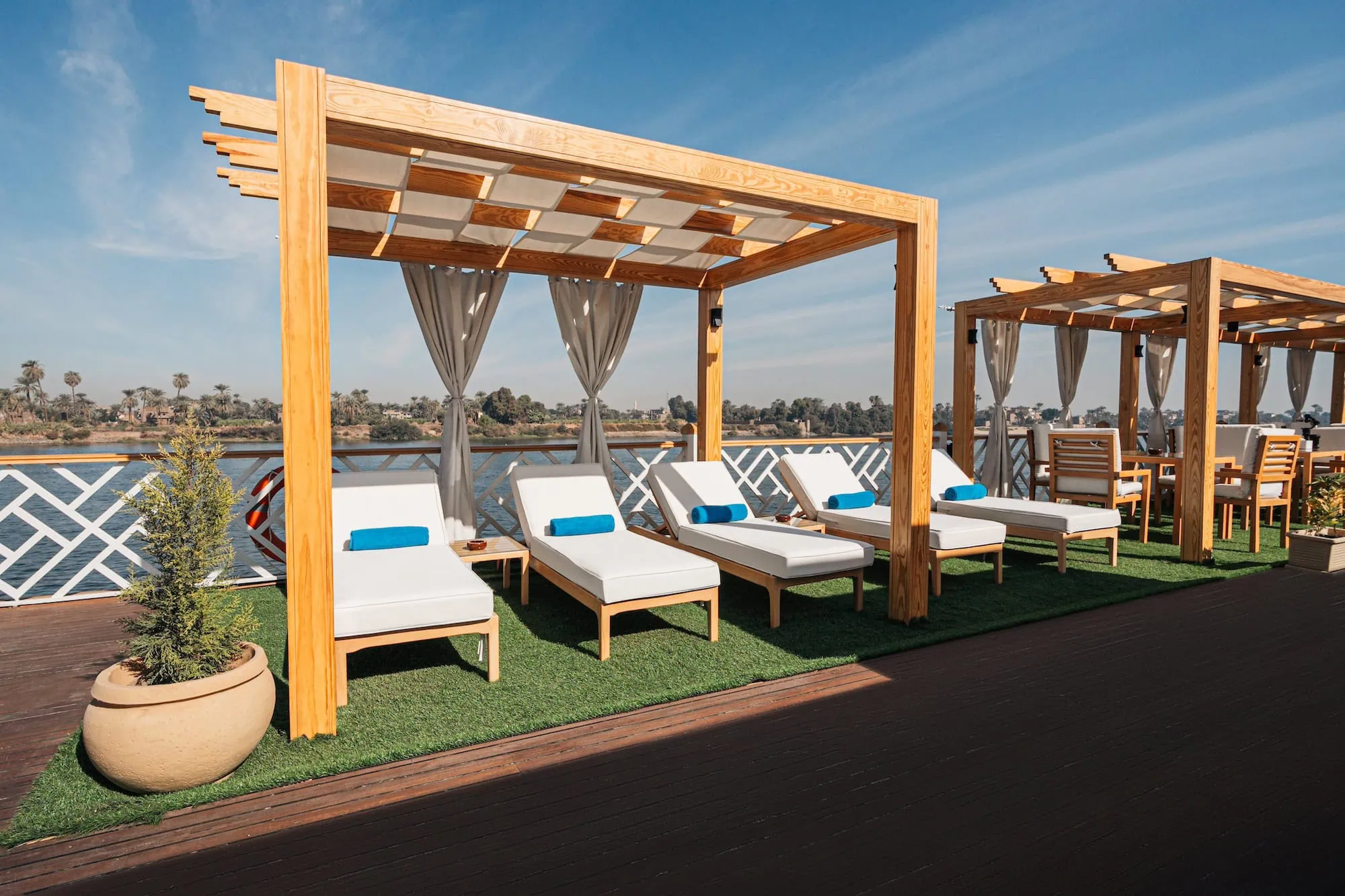 Shaded cruise ship deck with sun loungers and pergola on the Nile River