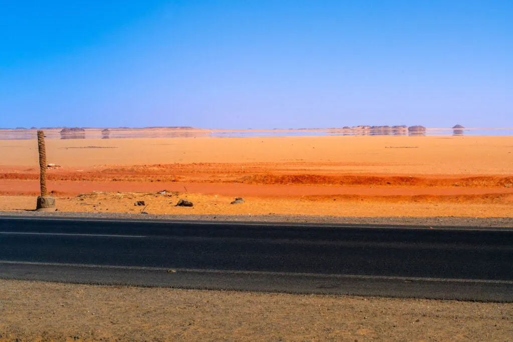 Mirage phenomenon creating reflective illusion on the roadside of the Aswan–Abu Simbel road, Aswan