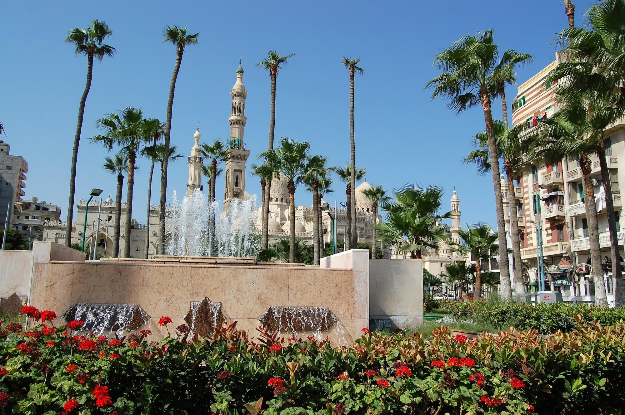 Abu al-Abbas al-Mursi Mosque with white minarets and fountain in Alexandria