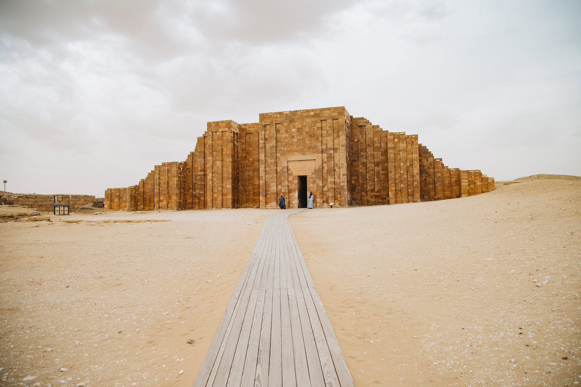 Step Pyramid of Djoser with wooden walkway entrance and visitors for guided tours
