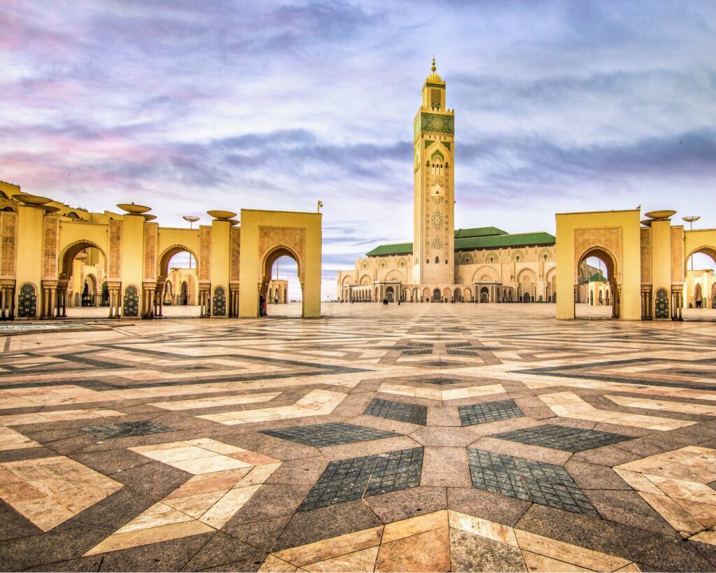 Wide paved square facing the Hassan II Mosque with ocean views and mosque minaret in the background, Casablanca