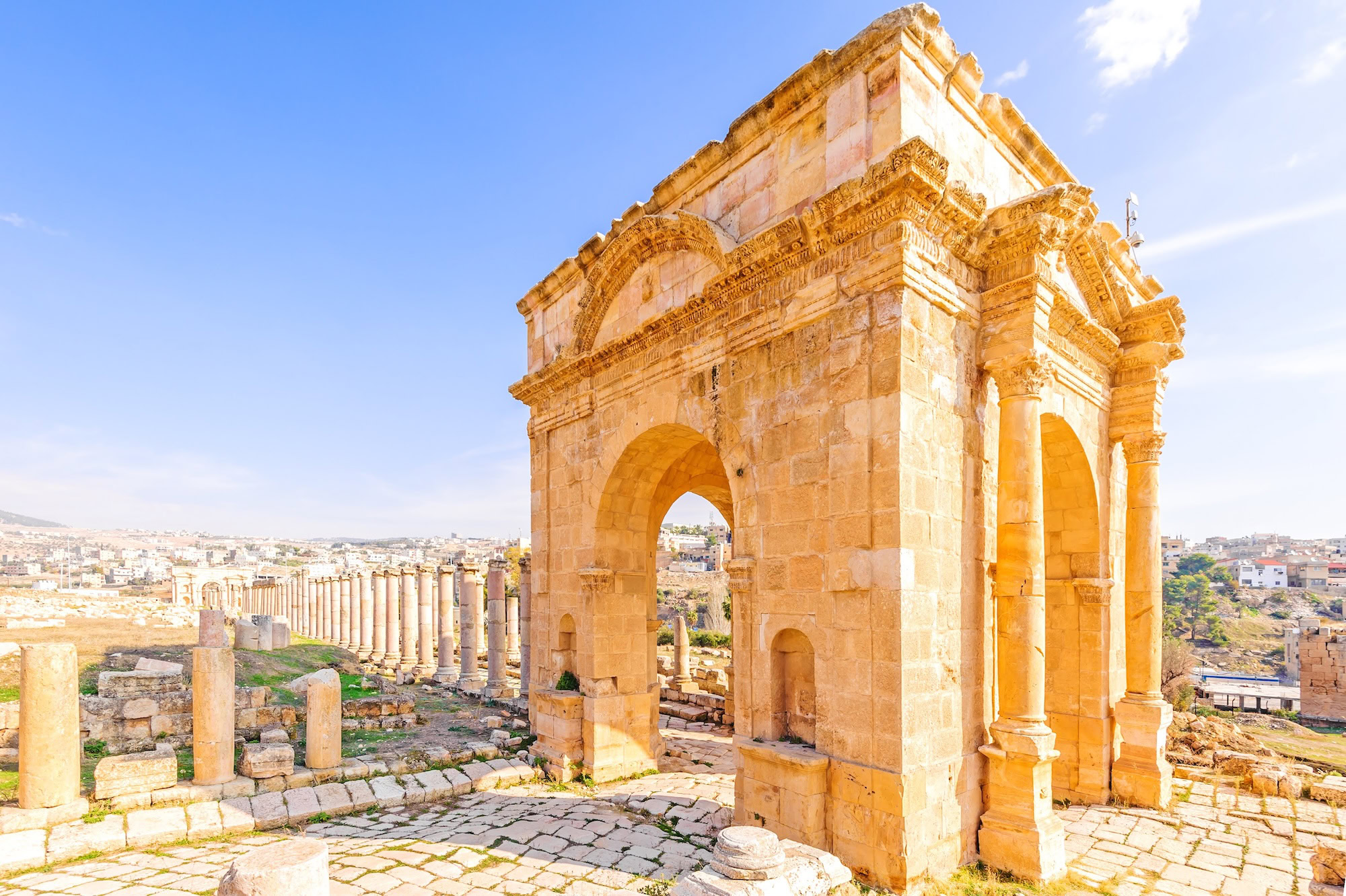 Ancient Roman arch and stone columns at Jerash archaeological site