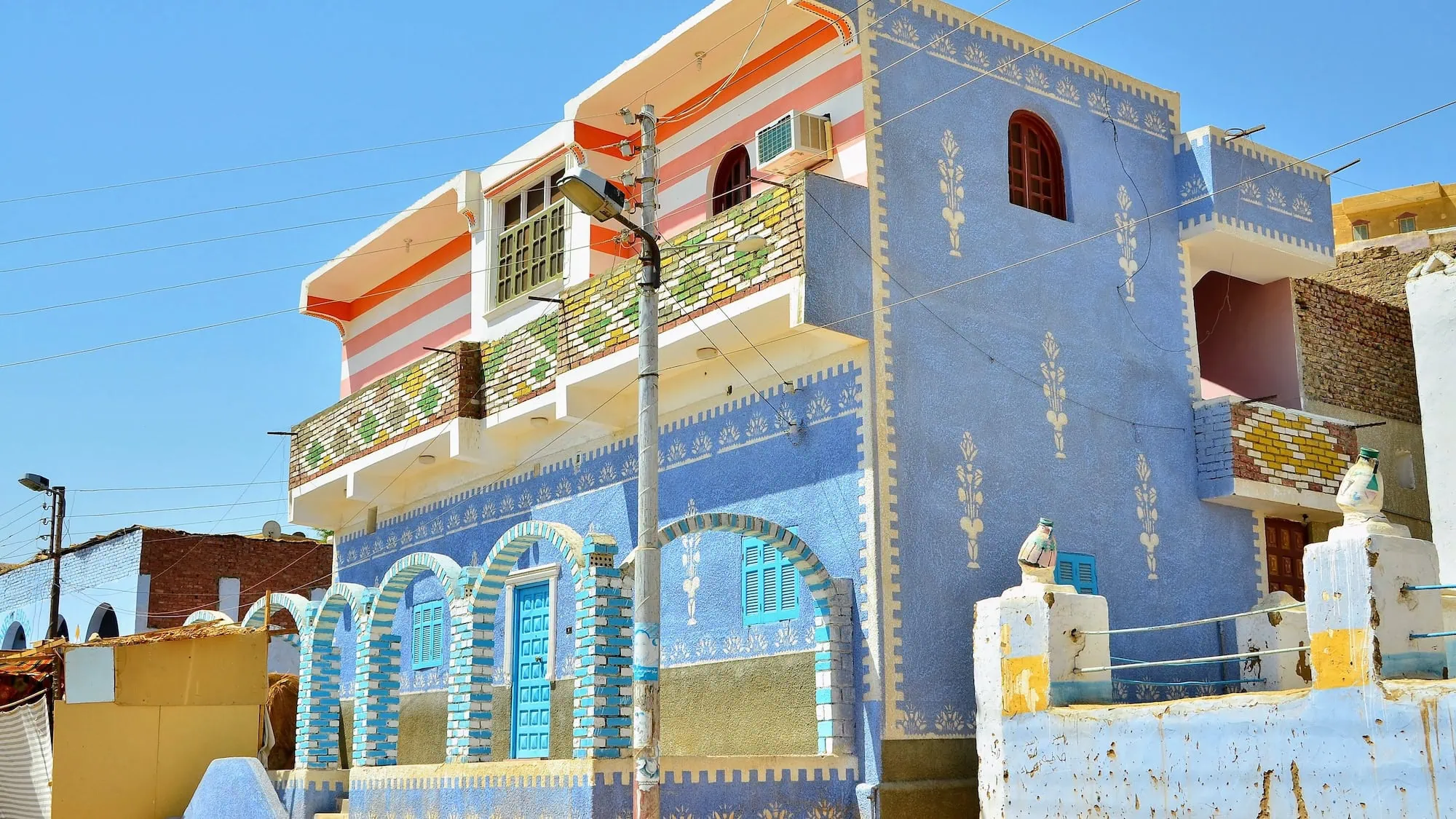Colorful Nubian village buildings with decorative patterns and traditional architecture near Aswan