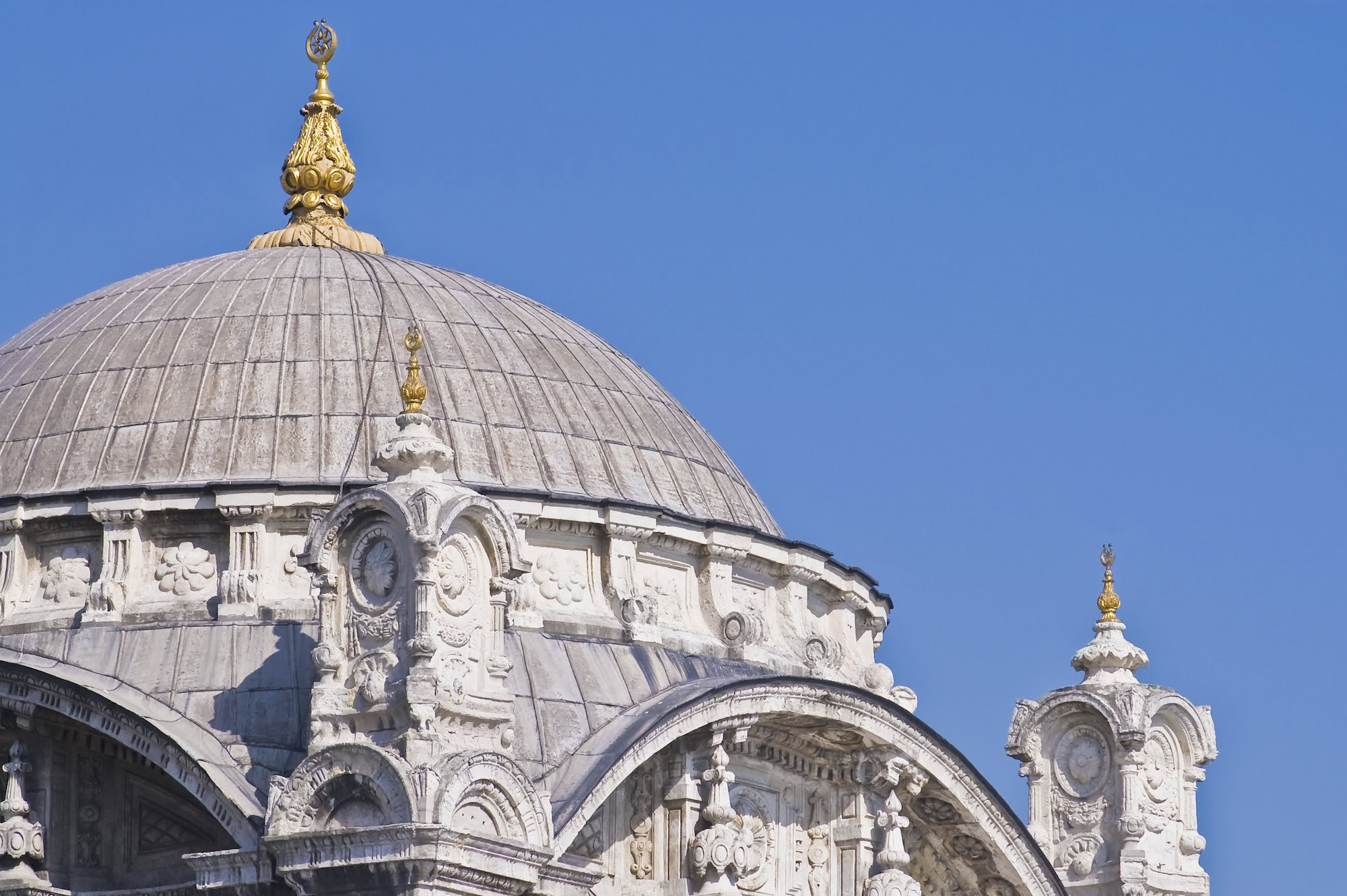 Majestic Ottoman mosque with golden domes and ornate Islamic architectural details
