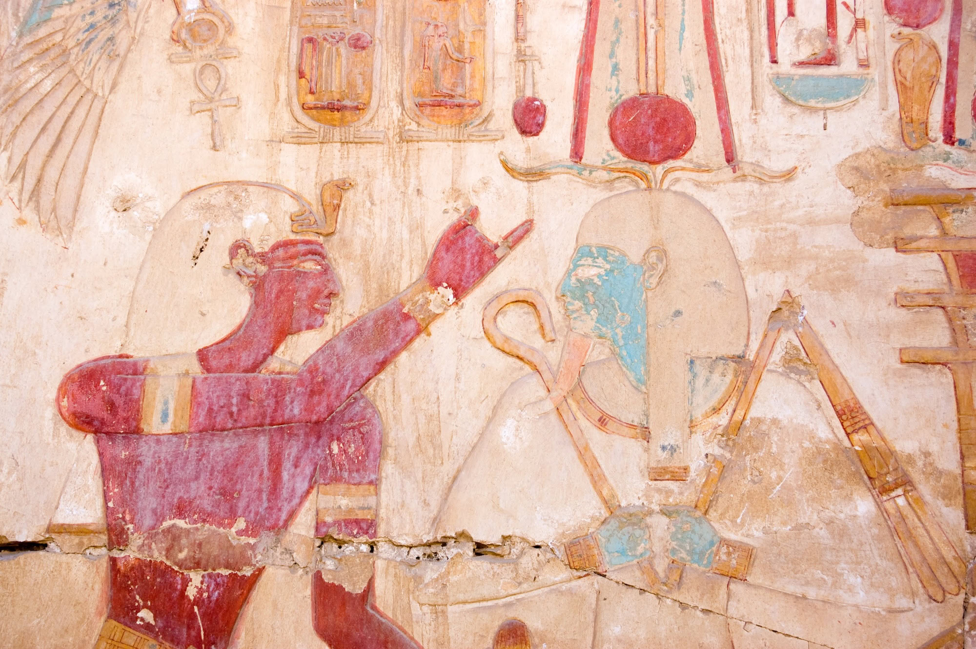 Ancient Egyptian wall painting showing hieroglyphics and pharaoh figure
