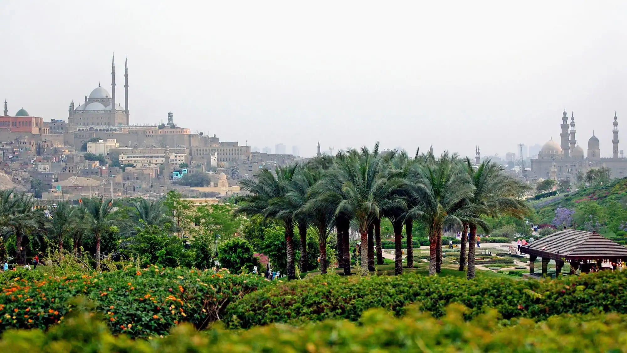 Mosque with minarets and dome situated on elevated Citadel of Saladin surrounded by gardens