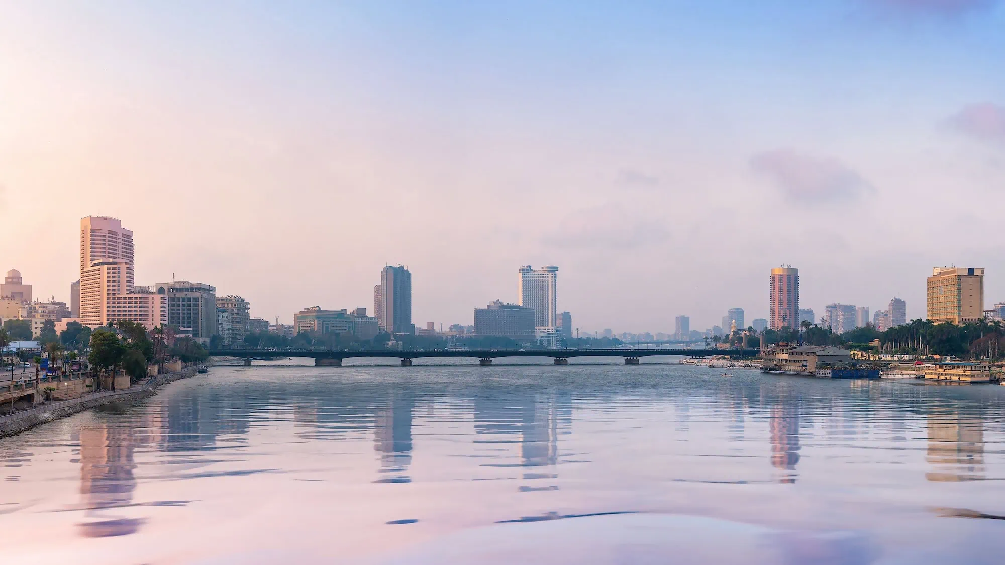 Nile River waterfront in Cairo with modern buildings and bridge